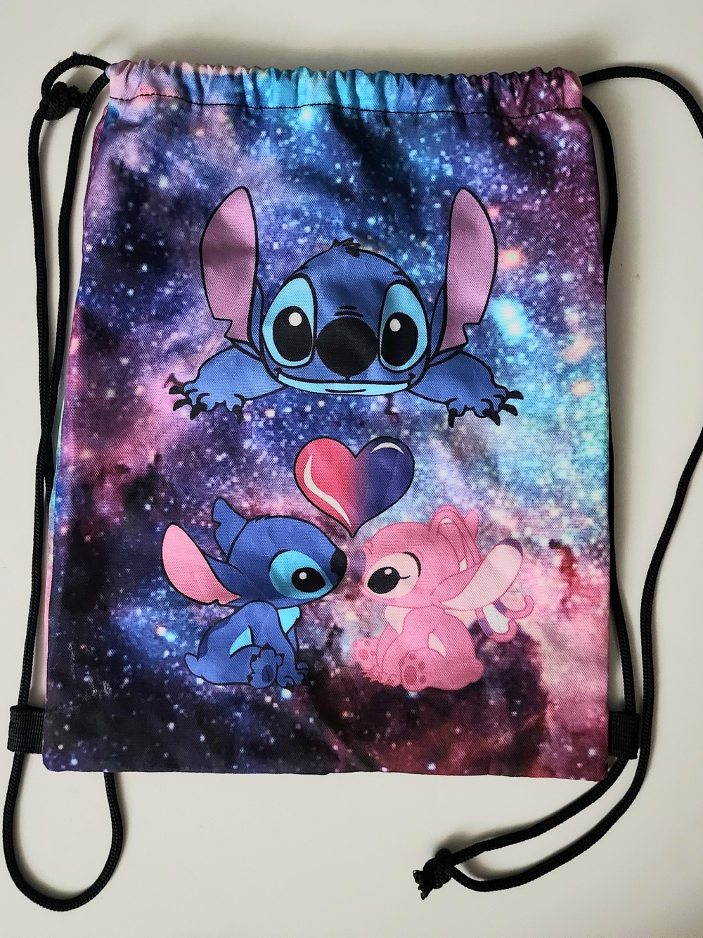 Galaxy Stitch Drawstring Backpack featuring Stitch and Angel